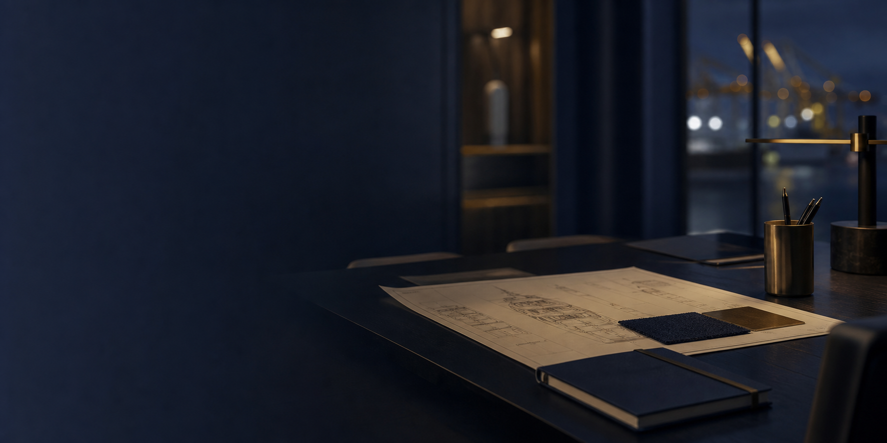 Discreet private office desk with superyacht governance material and shipyard lights.